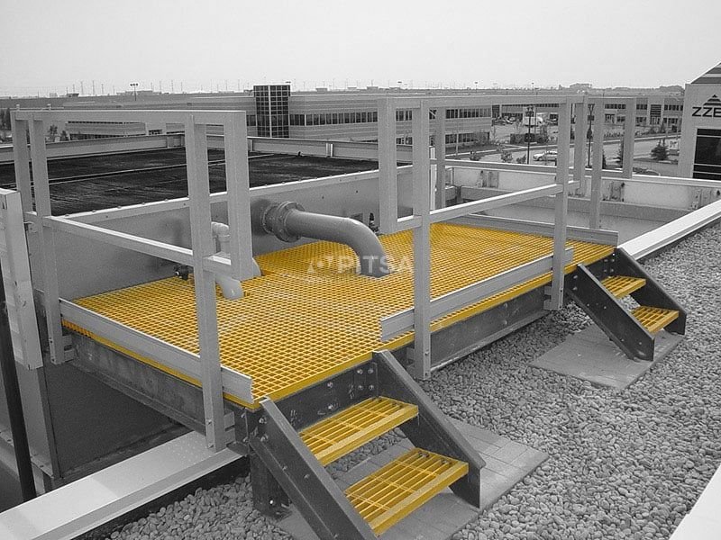 FRP grating platform installed on a roof in an industrial setting.