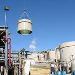 PITSA engineers supervising the installation of large diameter plastic FRP tanks using a crane.