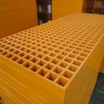 Stack of yellow FRP gratings suitable for corrosive environments.