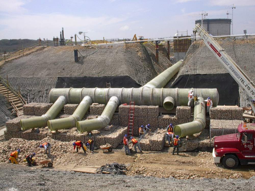 Large-diameter fiberglass duct system installed at an industrial site.