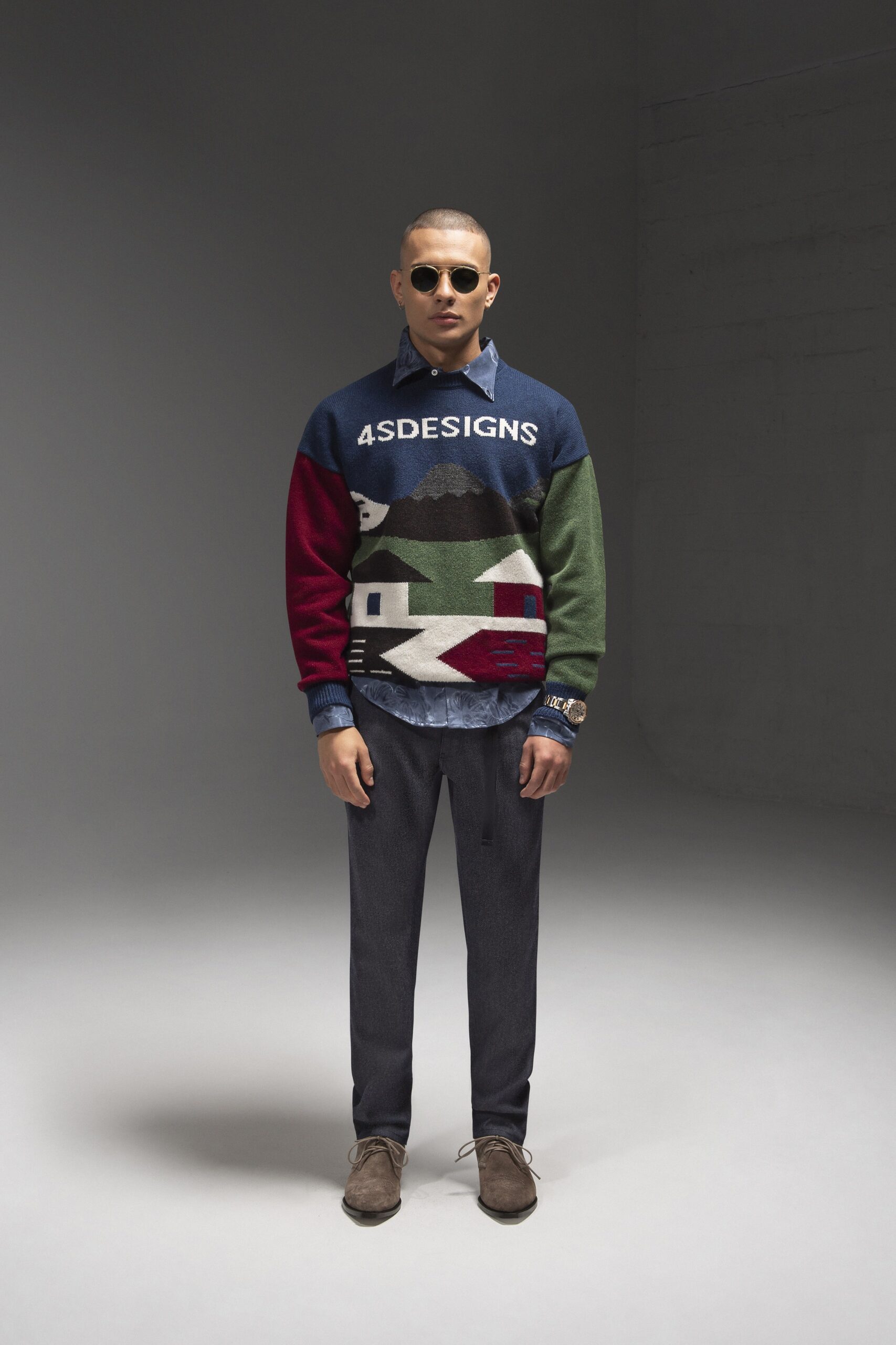 A relaxed fit sweater with a printed design paired with tailored pants.