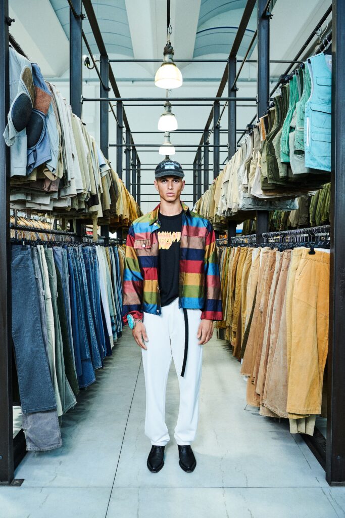 A relaxed-fit multicolor striped jacket paired with white pants, featuring a collared design.