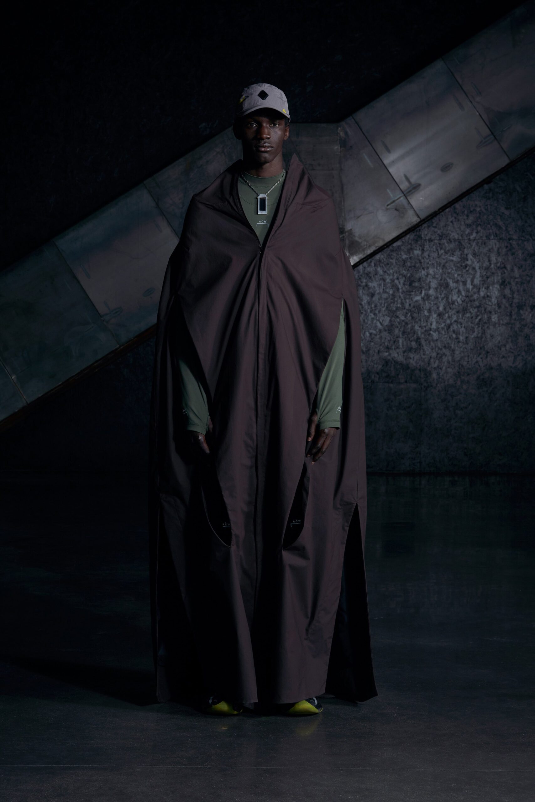 A relaxed brown cotton cape with long sleeves and an asymmetric design.