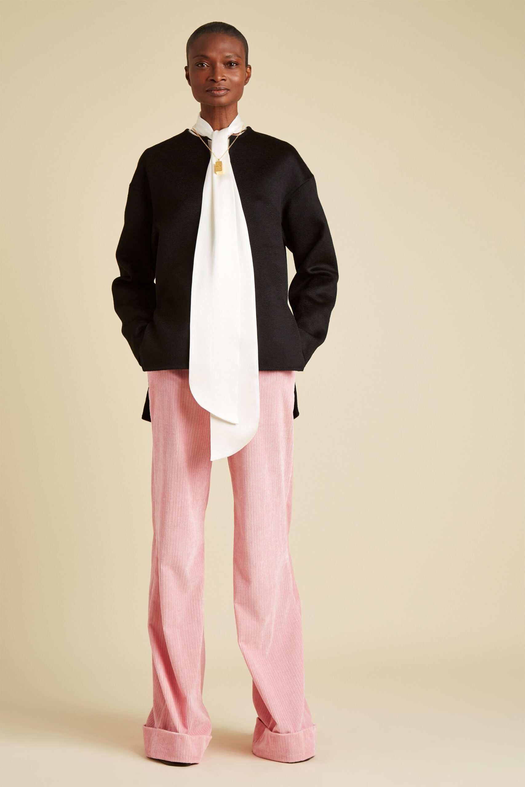 black relaxed top with pink tailored pants