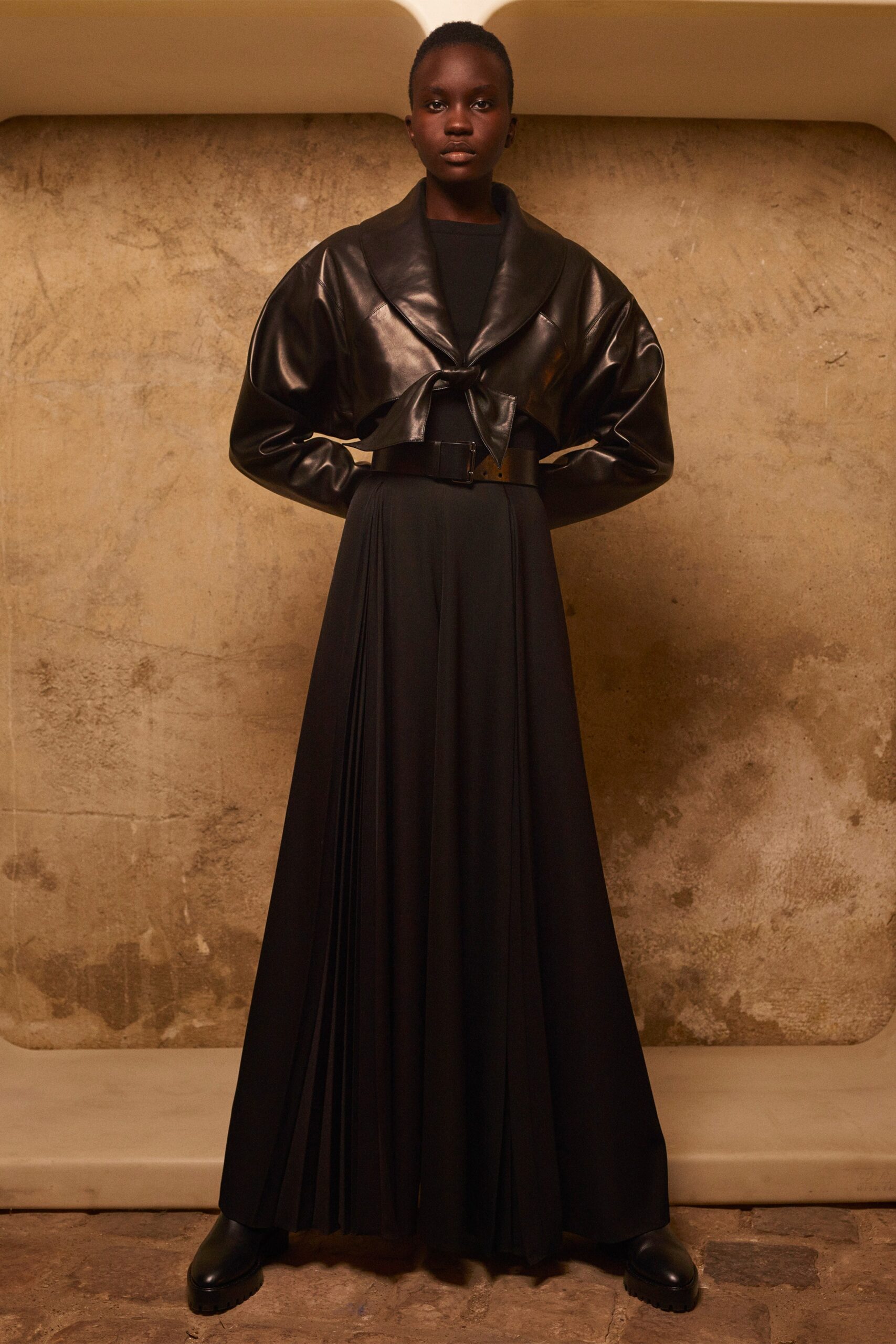 black leather jacket and pleated dress