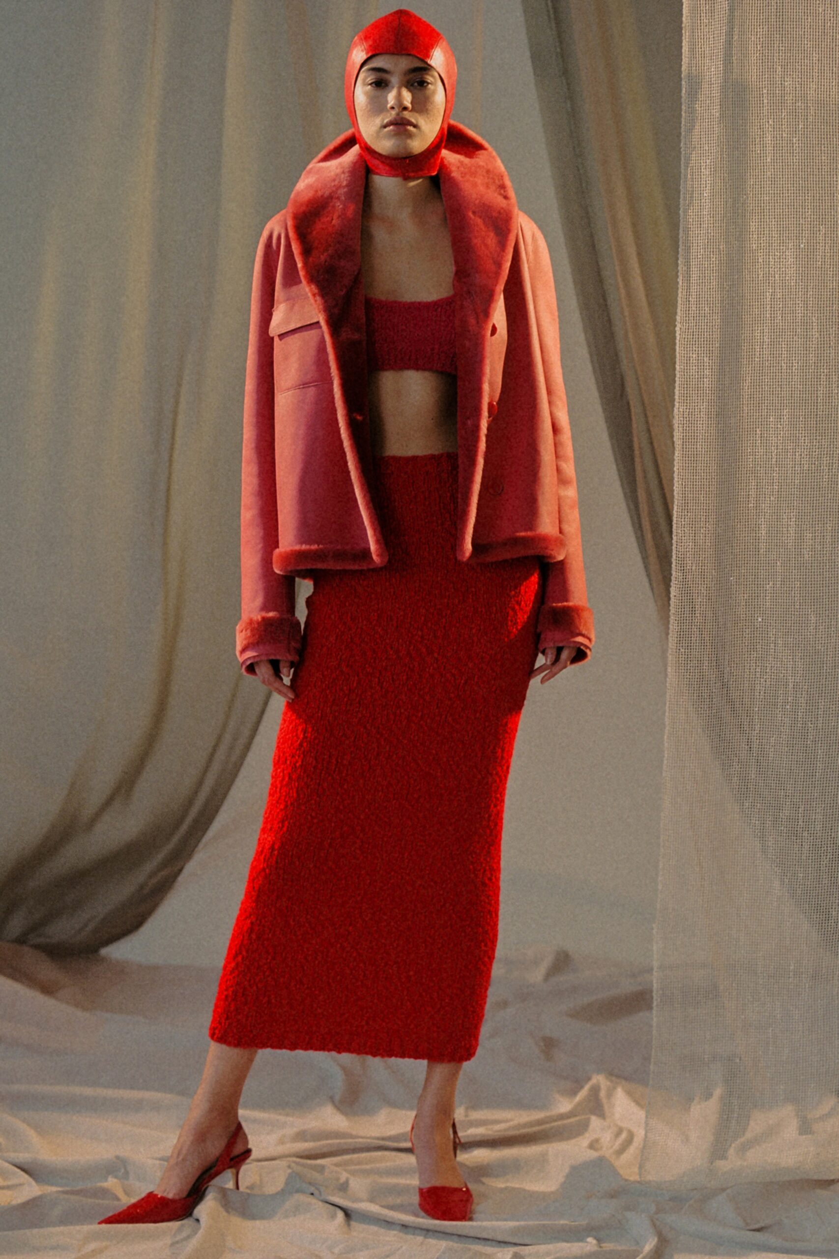 red faux-fur jacket with knit outfit