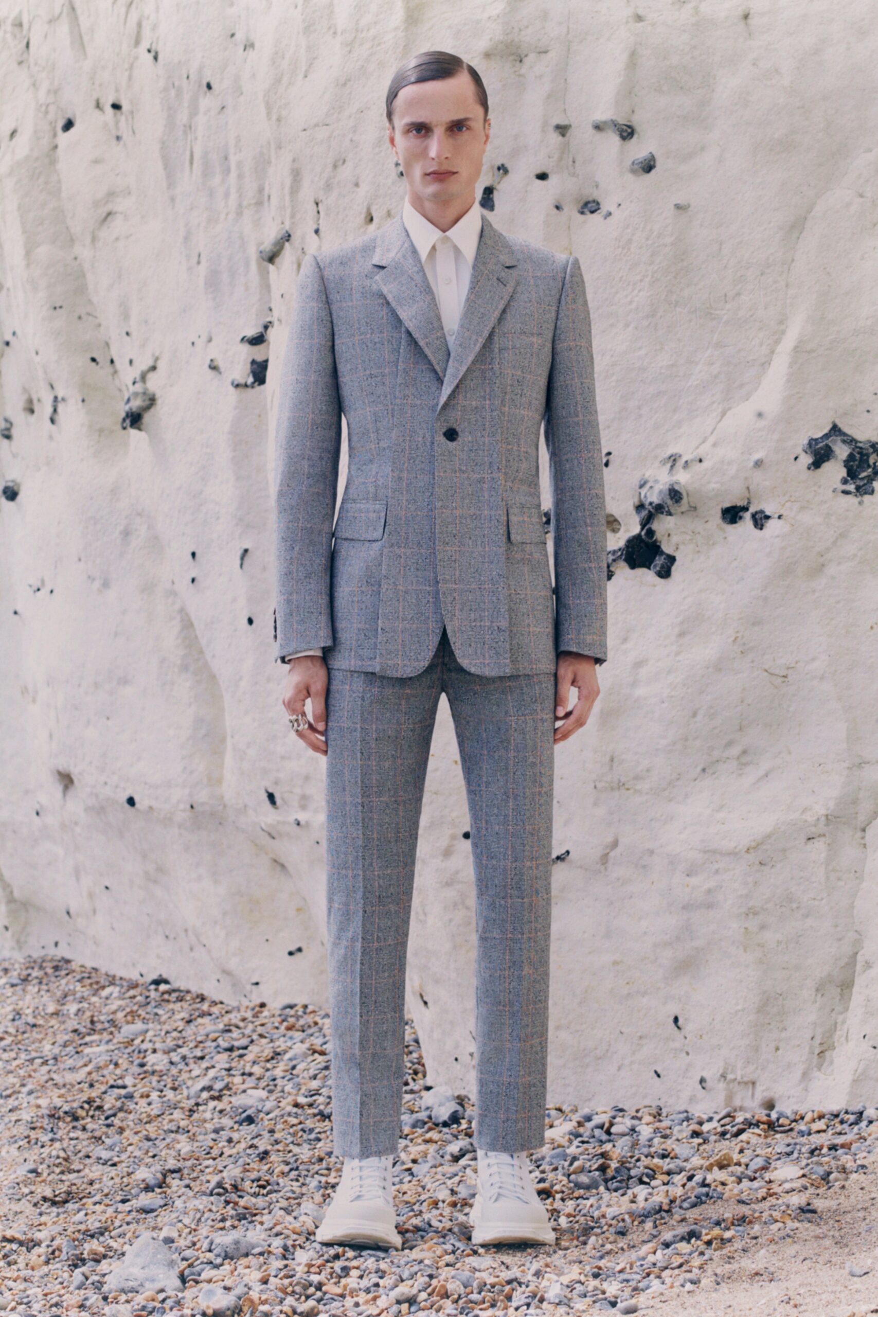 gray tailored suit with white shoes