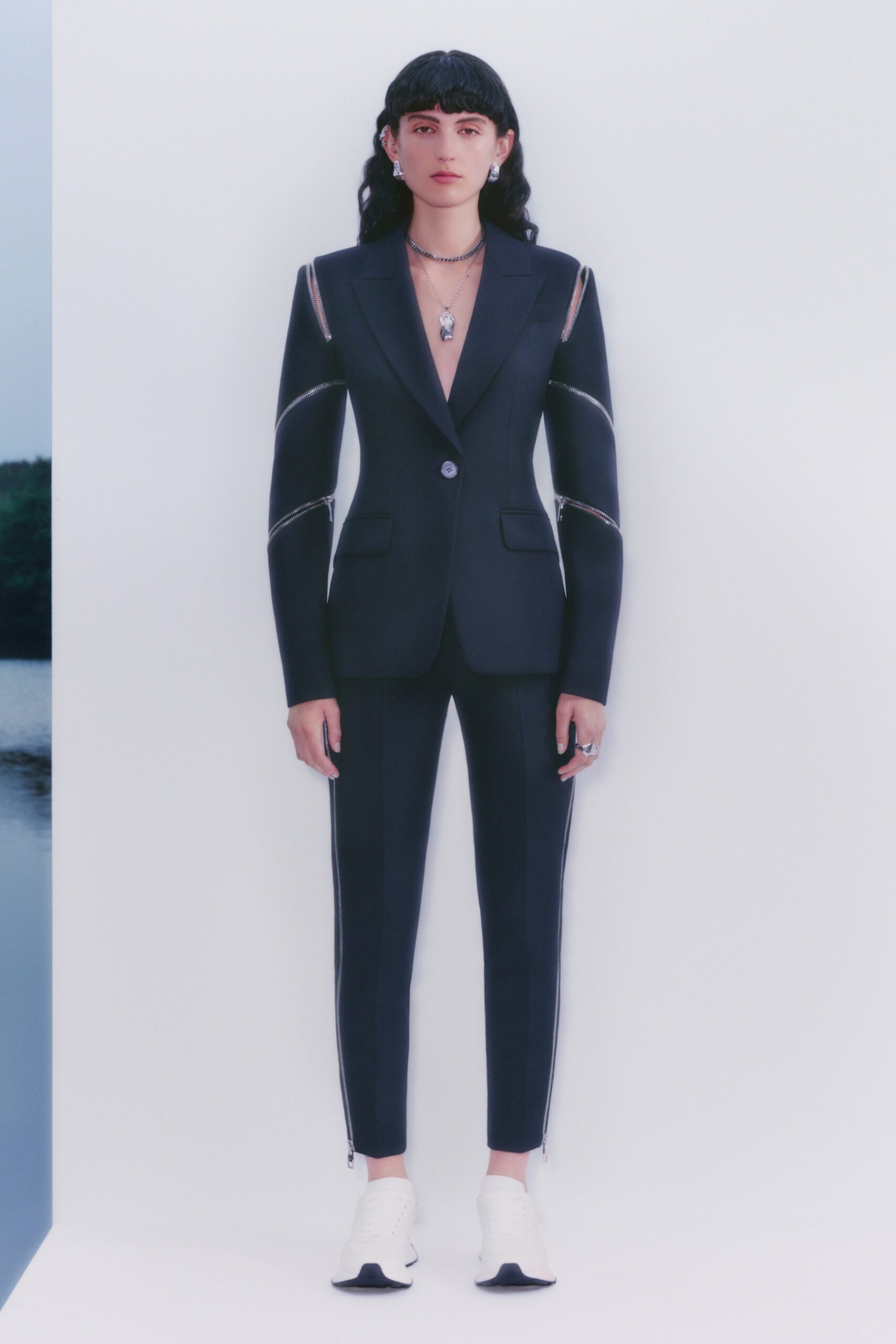 black tailored suit with white shoes