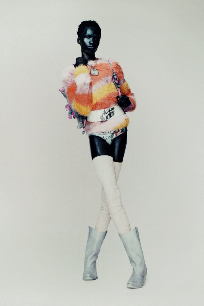 A fitted multicolor fur long-sleeve top paired with white fitted shorts.