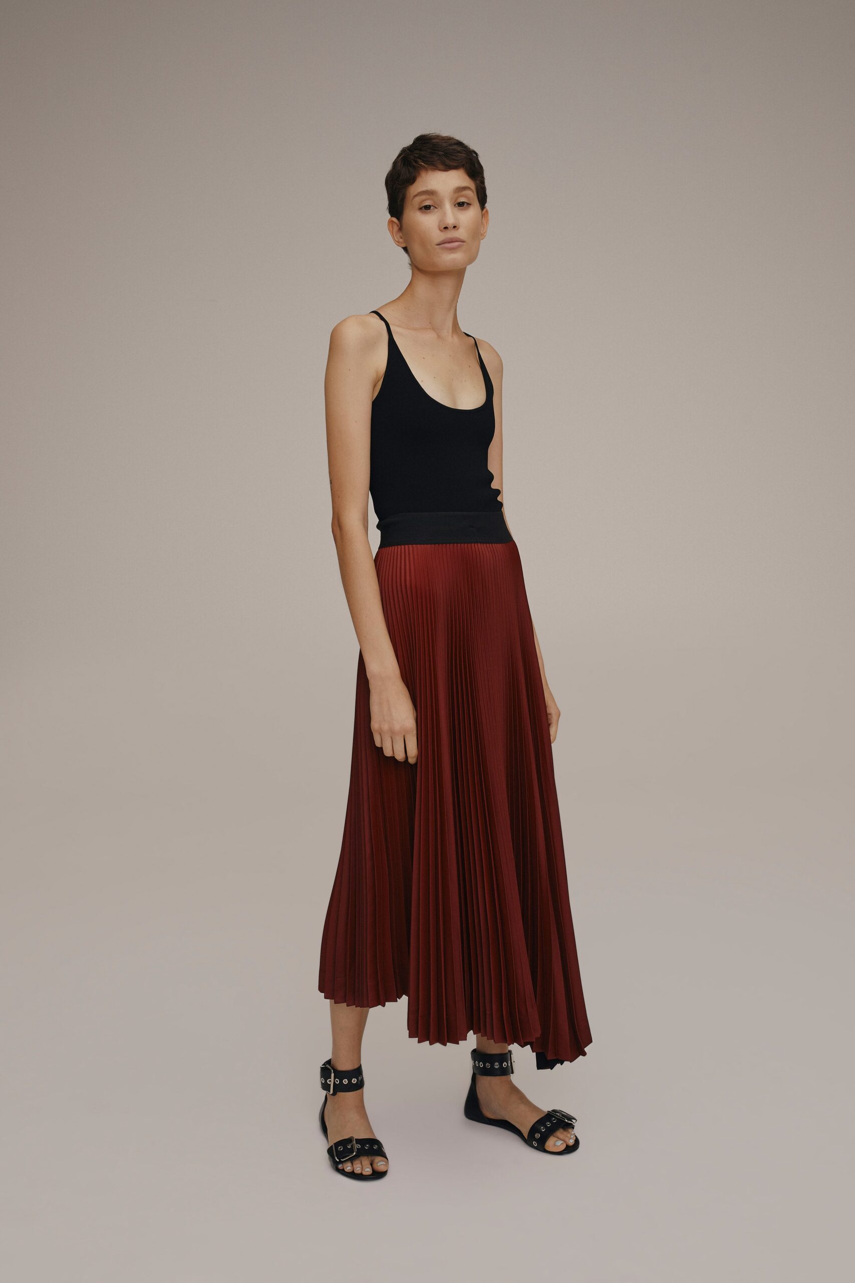 black fitted top red pleated skirt