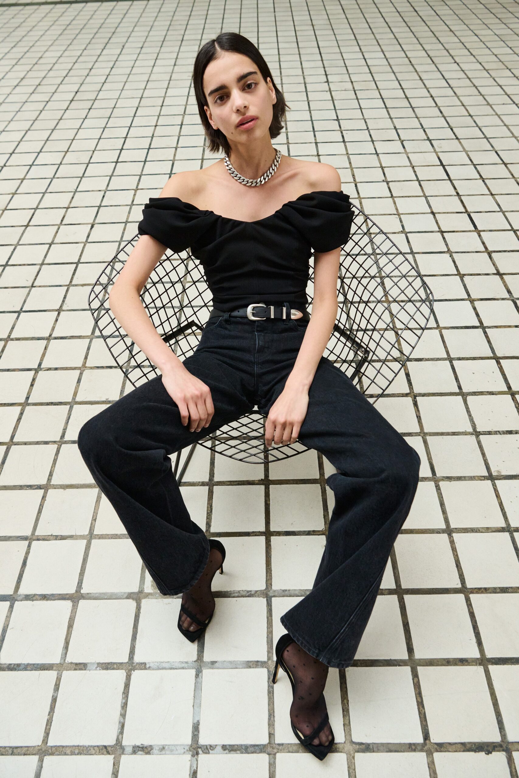 black off-shoulder top with flared pants