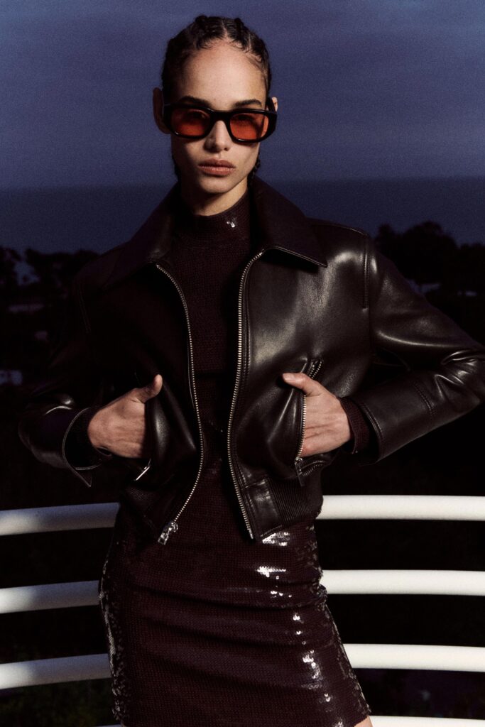 A fitted black leather dress paired with a matching jacket featuring a collared design.