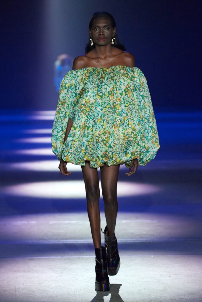 A relaxed green floral off-shoulder dress with a flared silhouette.
