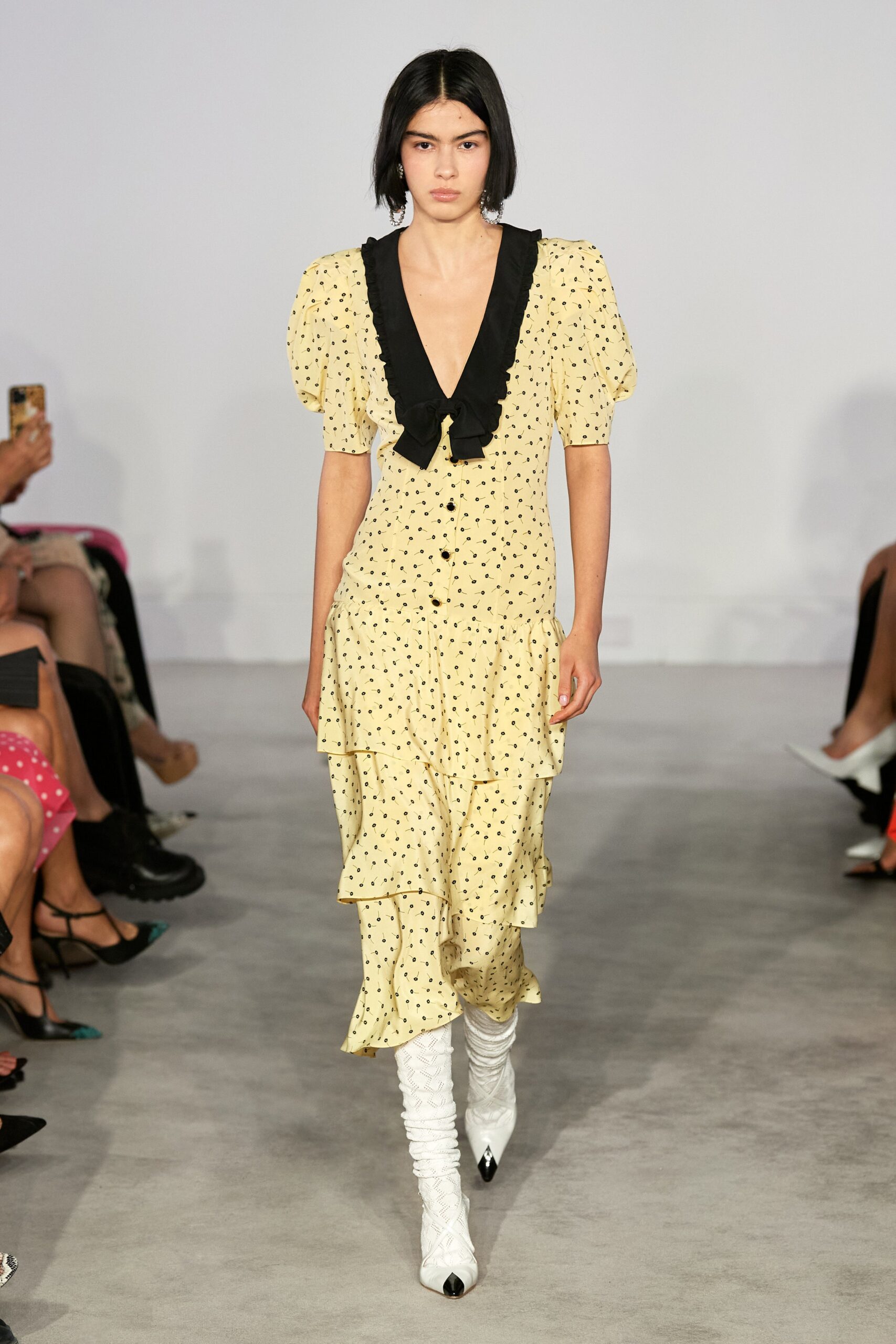 yellow and black ruffled midi dress with white boots