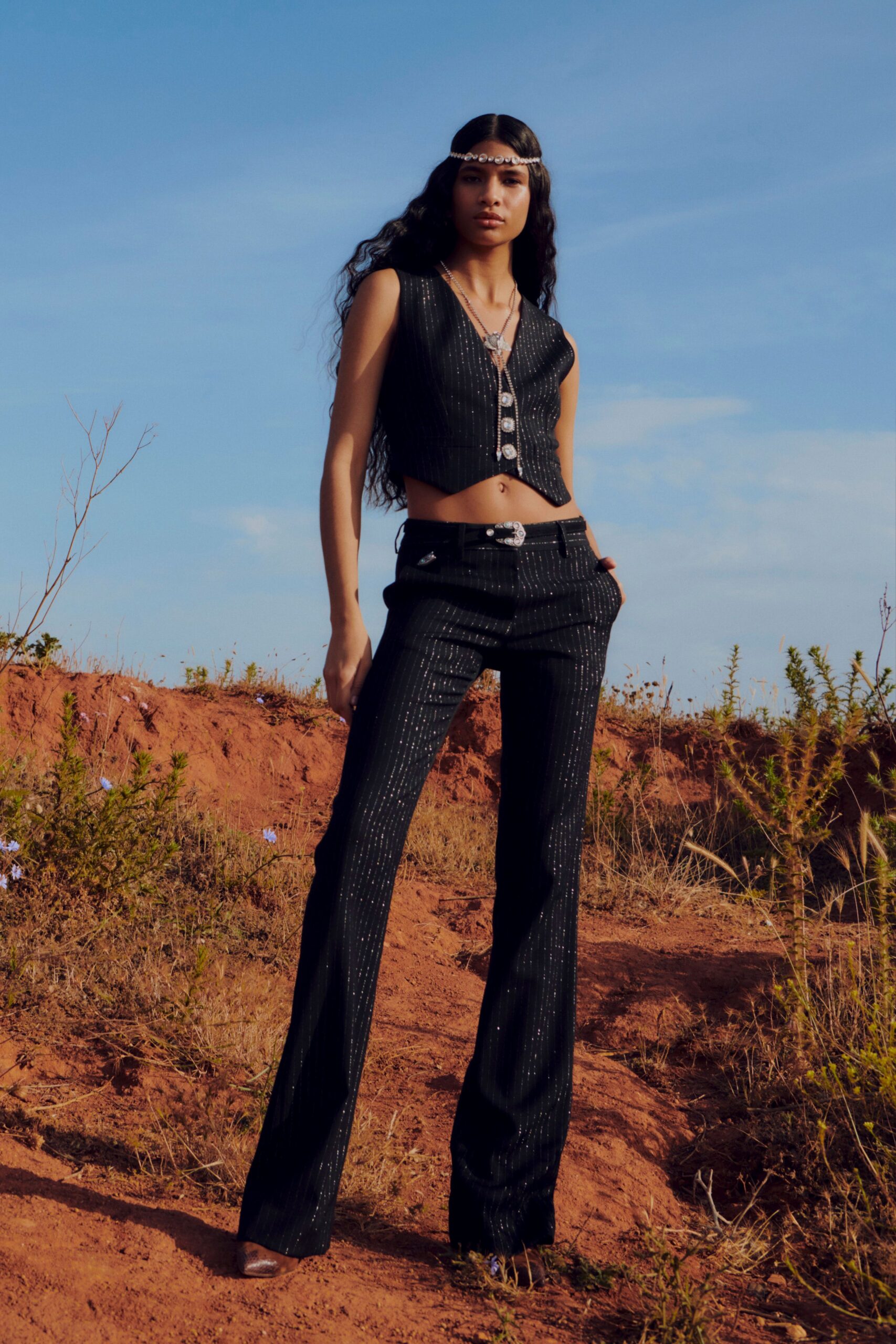 black fitted vest and flared pants