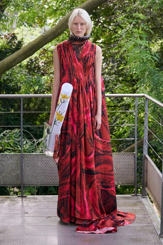 A relaxed red silk sleeveless dress with a V-neckline and flared silhouette.