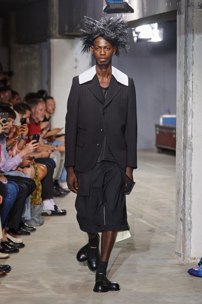 A relaxed black and white striped suit with a collared short-sleeve shirt and shorts.