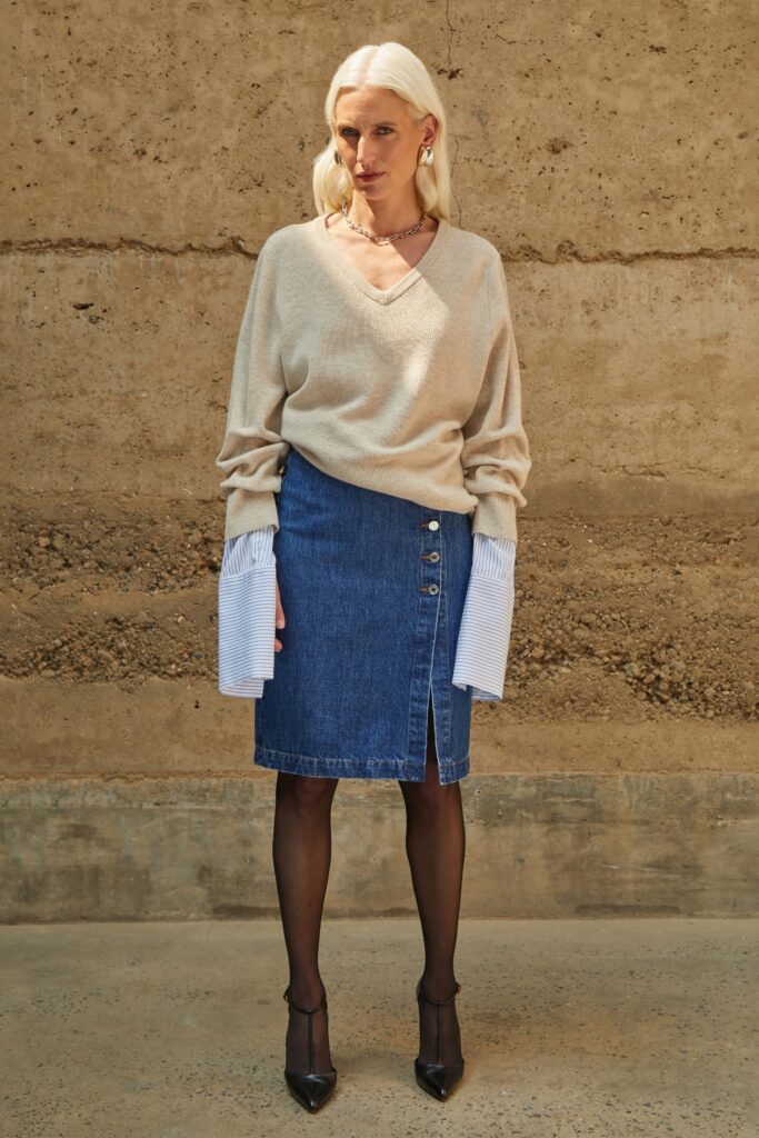 beige relaxed sweater with blue denim skirt