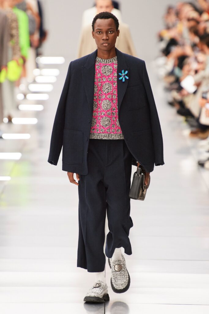 A relaxed navy jacket paired with cotton pants, featuring a long-sleeve and collared design.
