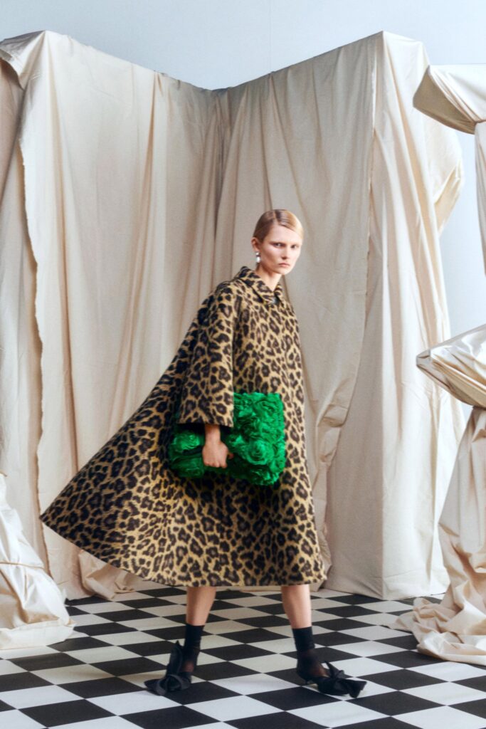 brown animal-print coat with green bag