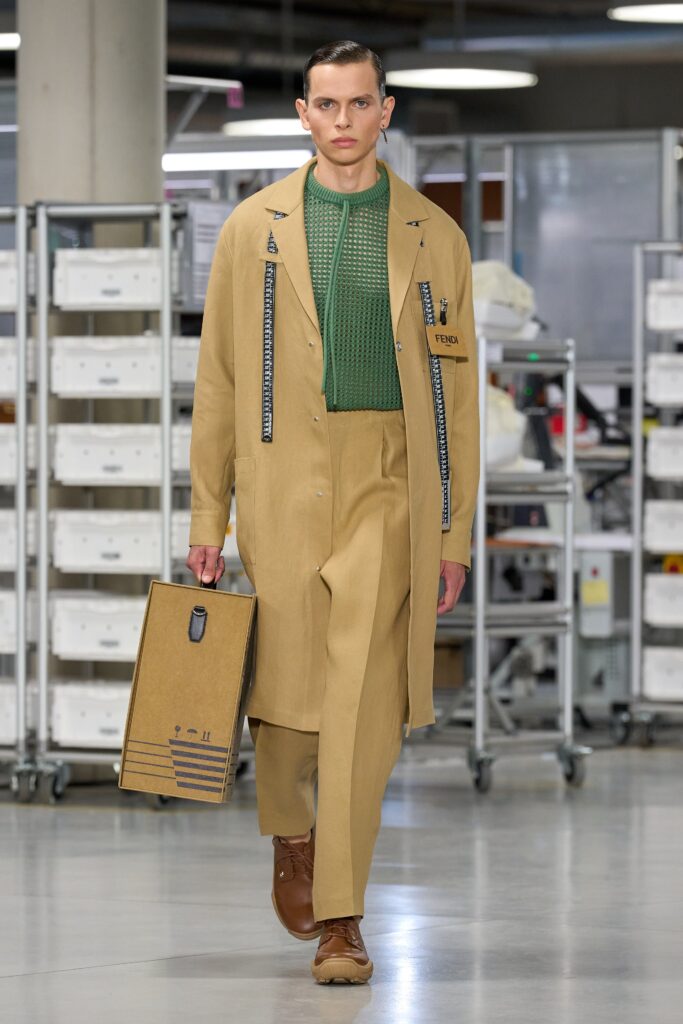 A relaxed beige coat with long sleeves and collared design paired with straight-leg pants.
