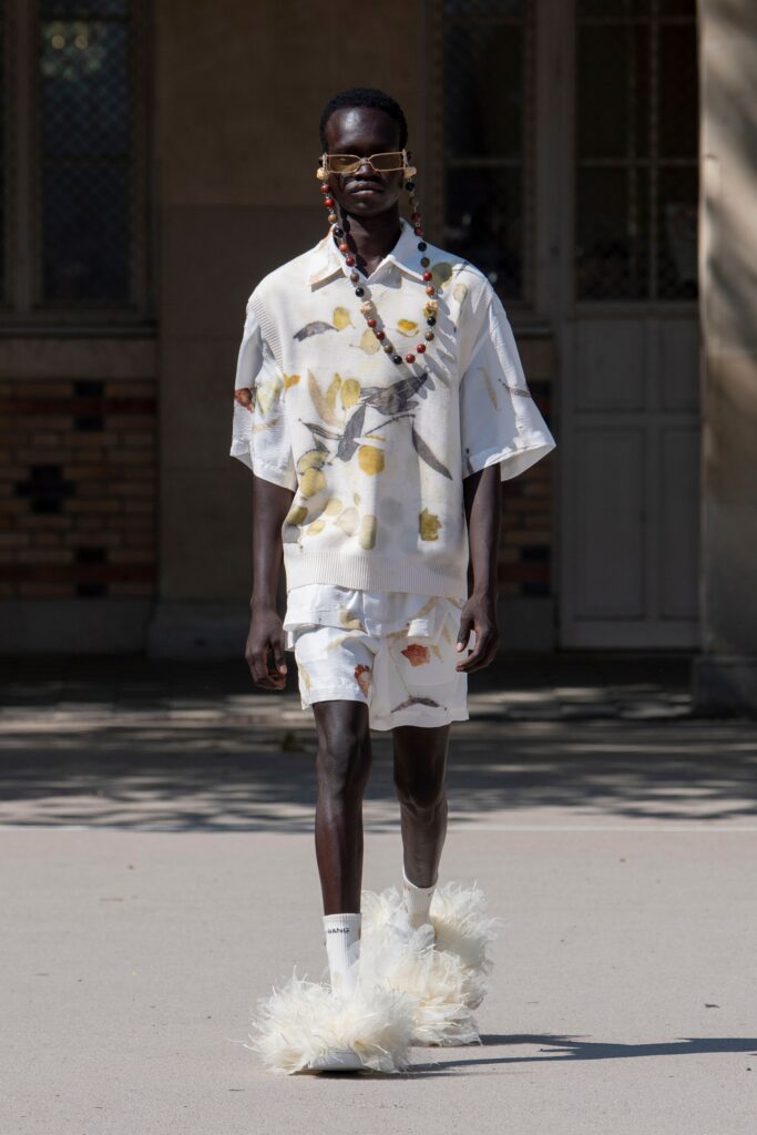 A relaxed-fit white shirt with a collar and printed design, paired with matching shorts.