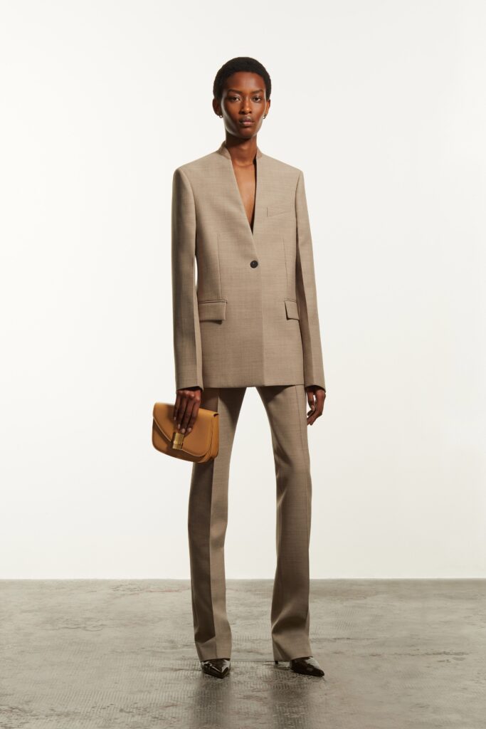 A tailored beige suit with a V-neckline and straight-leg pants.