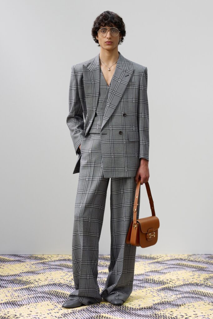 A tailored gray checked suit featuring a long-sleeve collared jacket.