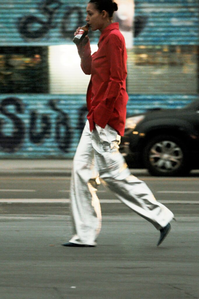 A relaxed red long-sleeve collared shirt paired with wide-leg silver pants.