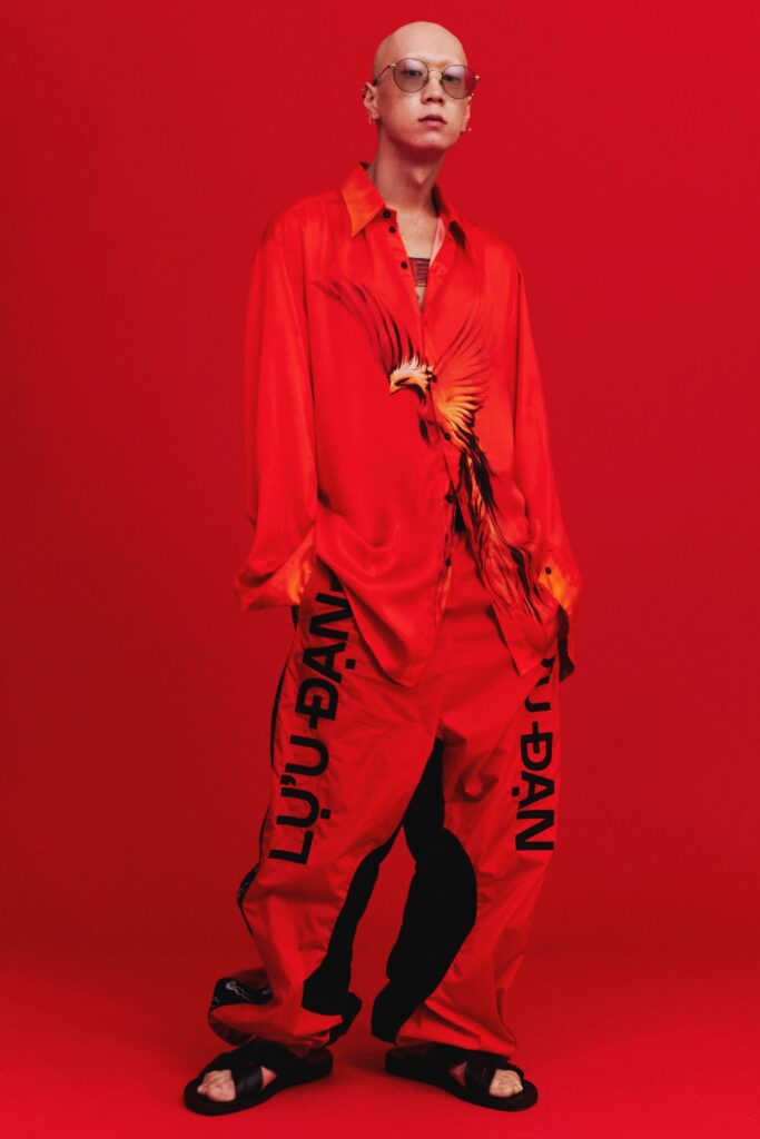 A relaxed fit red shirt with long sleeves and printed pants, creating a bold fashion statement.