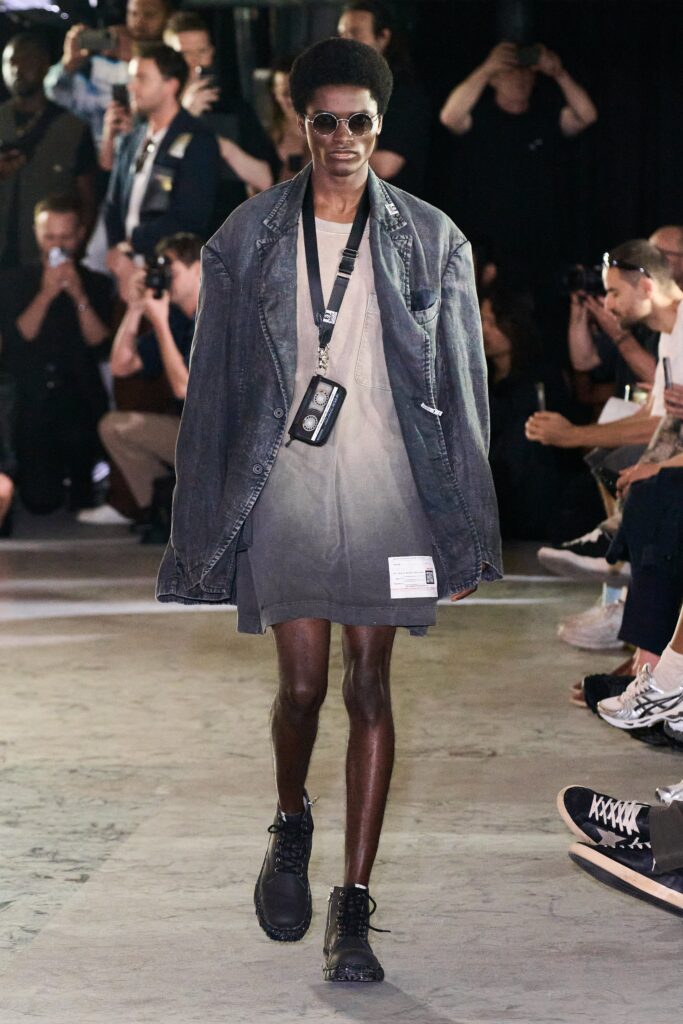 An oversized gray denim dress with a long-sleeve collared jacket and asymmetric design.