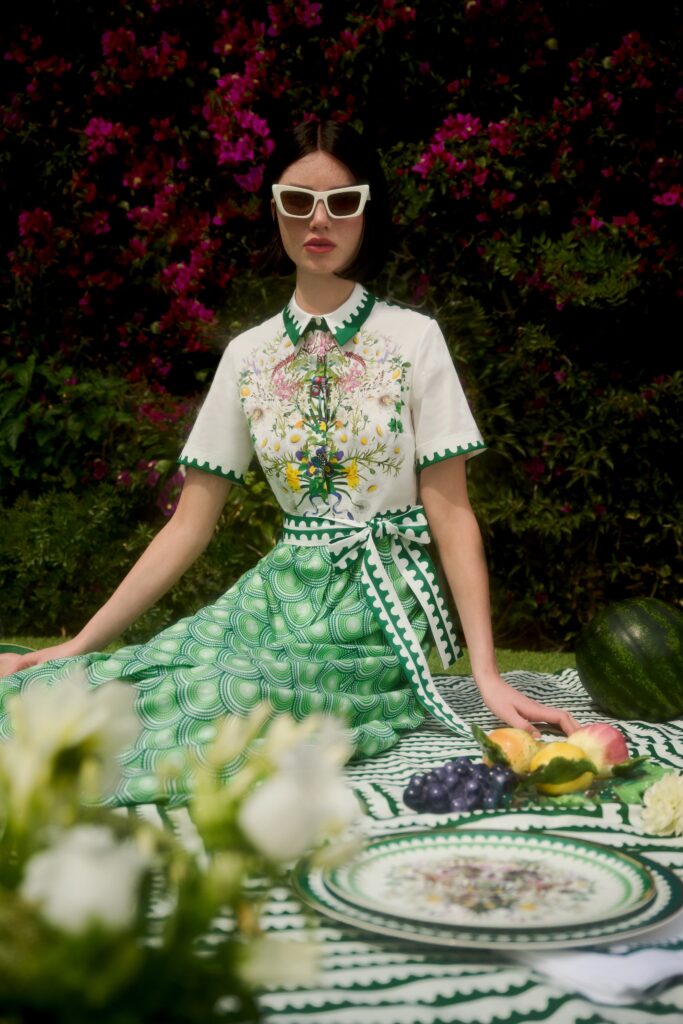 A fitted green and white floral dress with short sleeves and a flared silhouette.