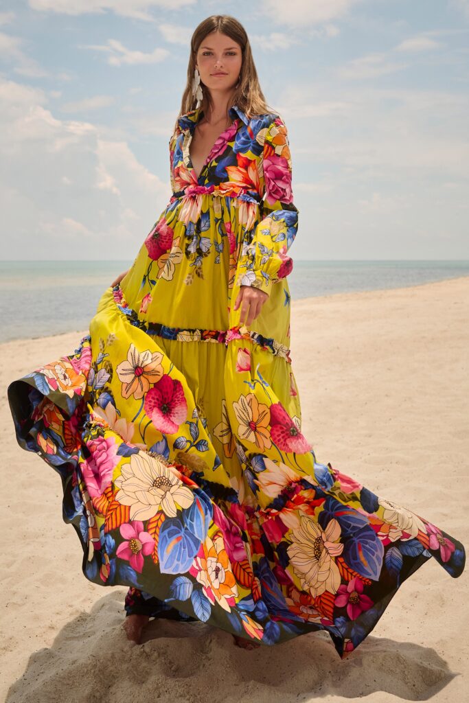A relaxed yellow floral dress with long sleeves and a V-neckline, featuring a tiered design.