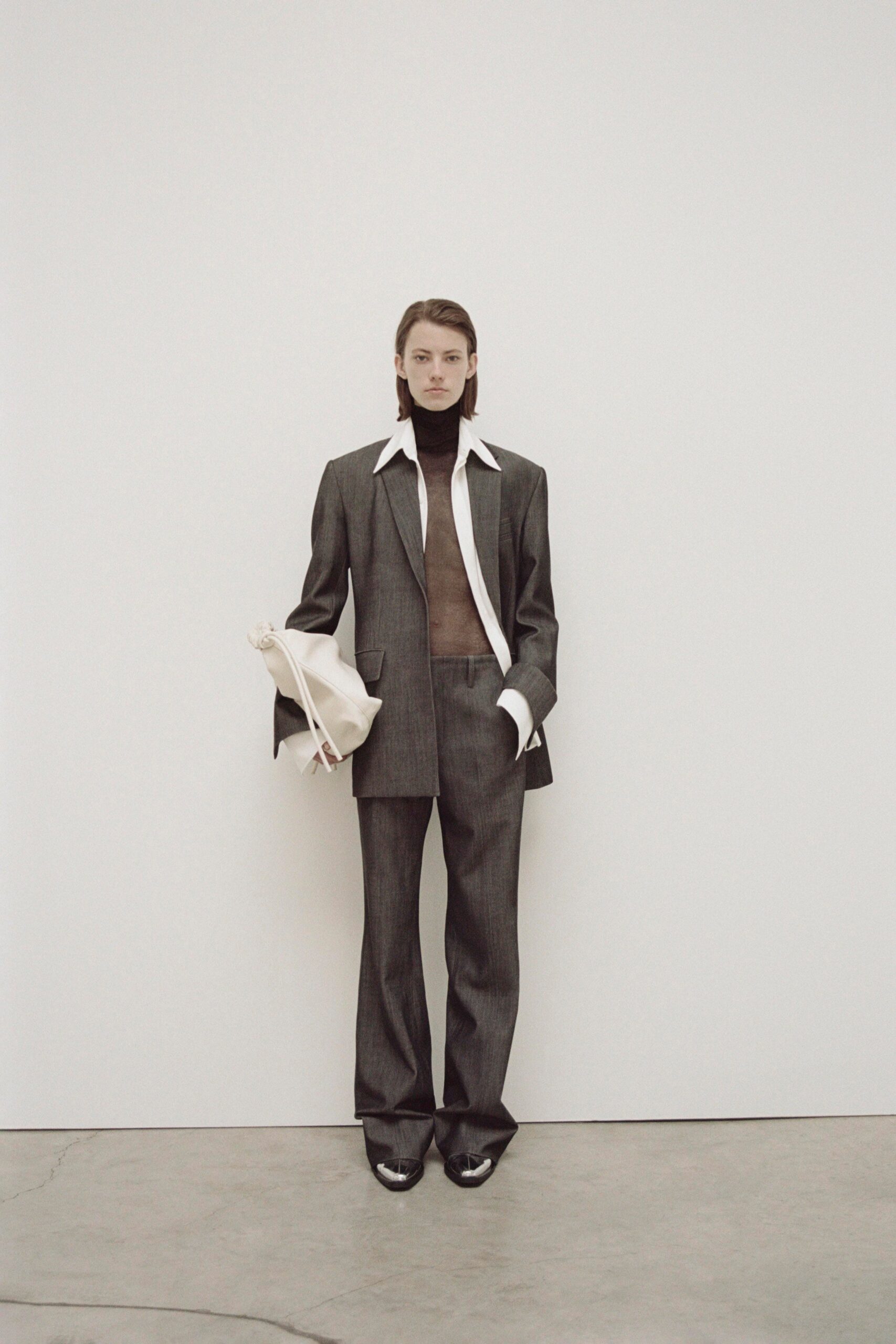 A tailored gray wool suit with a collared long-sleeve shirt and straight-leg trousers.