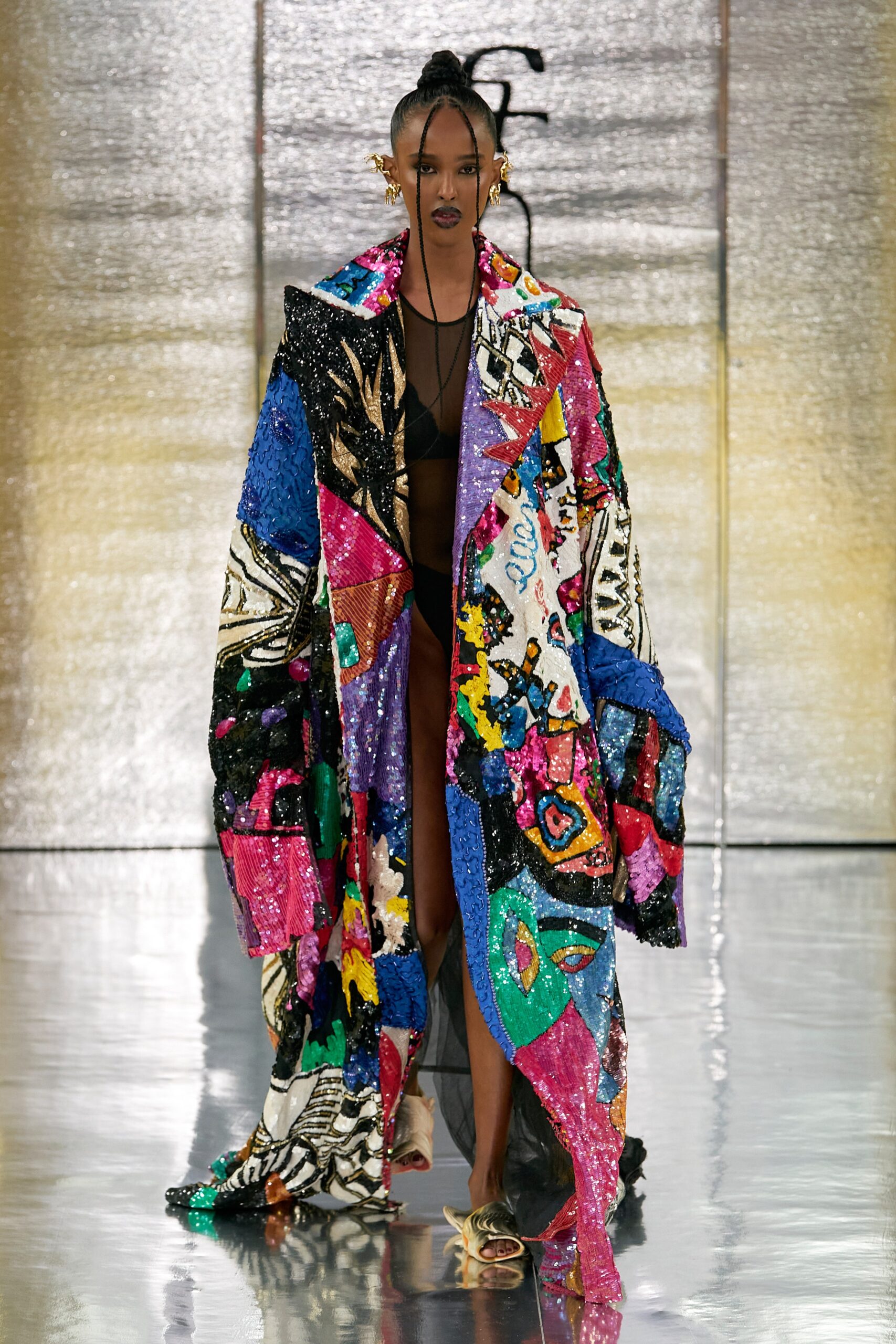 An oversized multicolor coat made of sequins with long sleeves and a layered design.