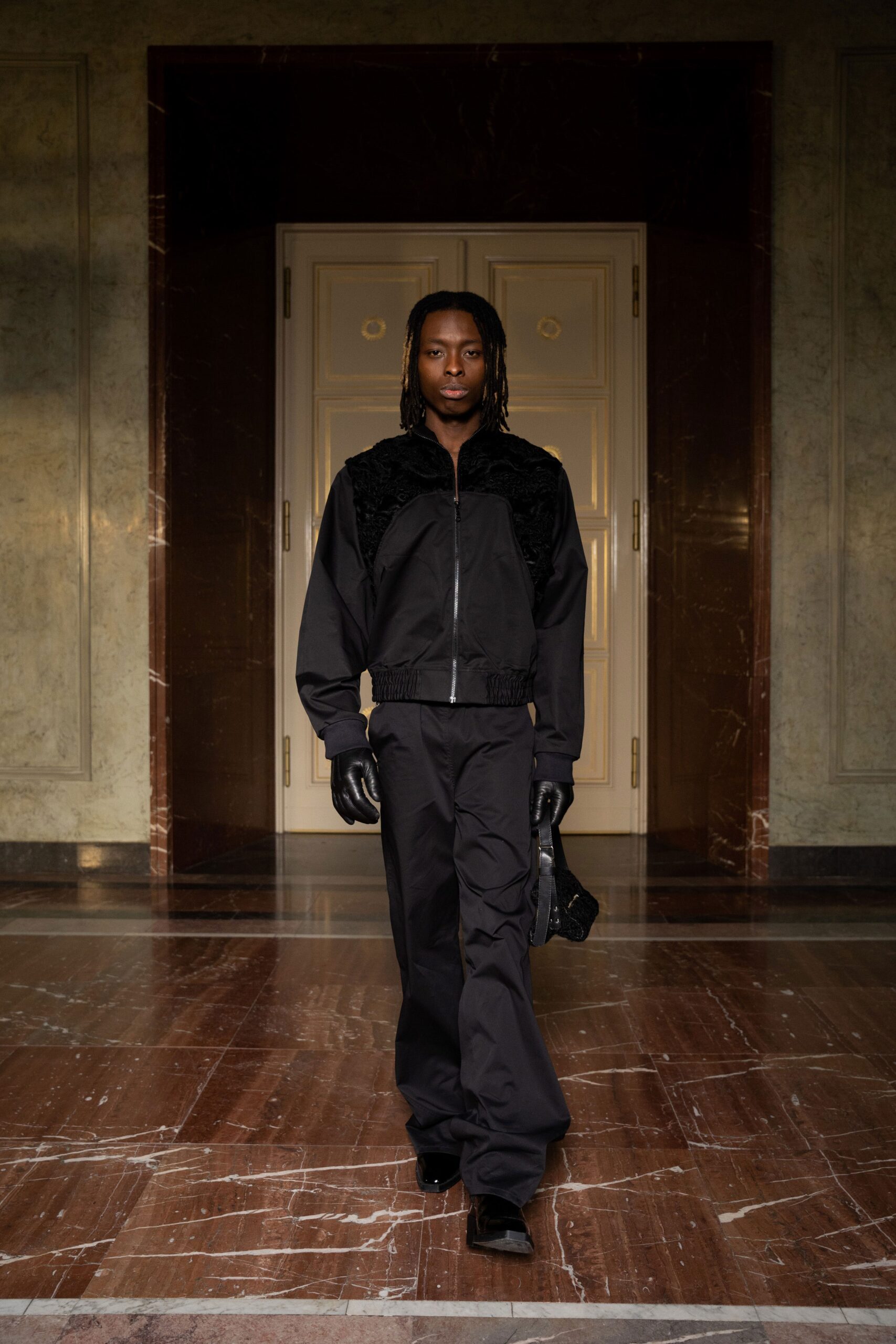 A relaxed black jacket with long sleeves and a collared design paired with matching pants.