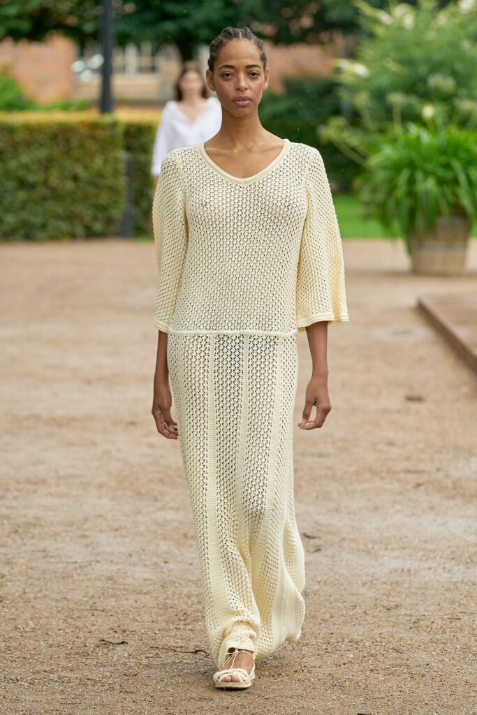 A relaxed cream knit short-sleeve dress with a V-neckline and maxi length.