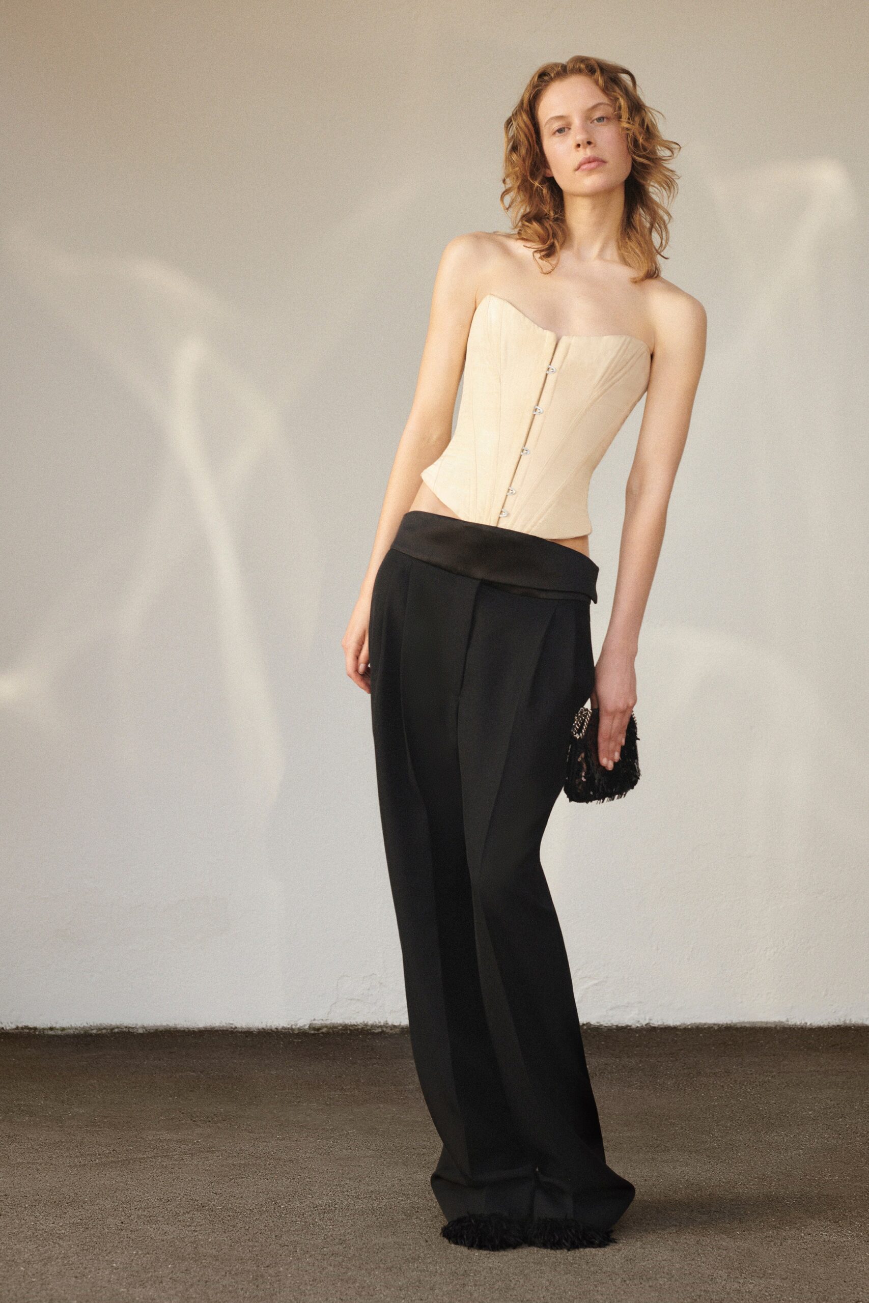 beige corset and black pants