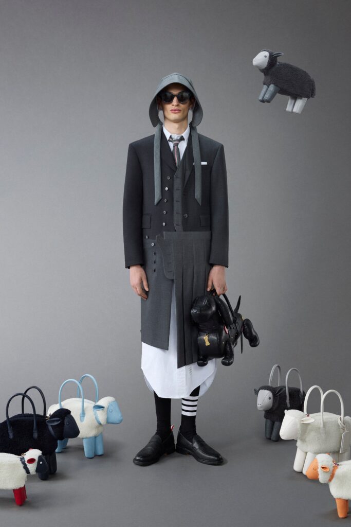 A structured black and gray wool coat with a pleated design and buttoned details.