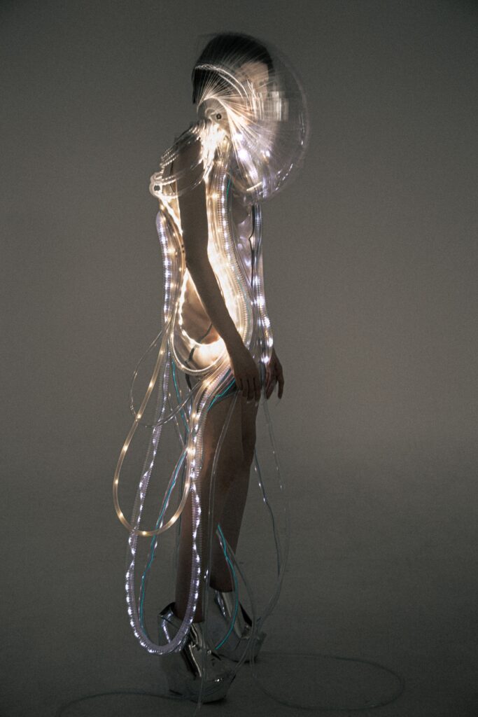 A fitted multicolor sleeveless dress with an asymmetric design and unique light elements.