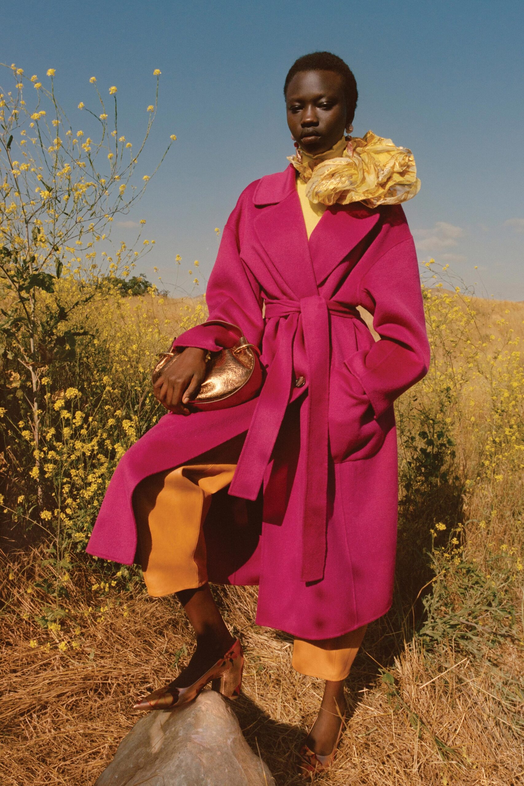 A relaxed pink wool coat with long sleeves and a belted design.