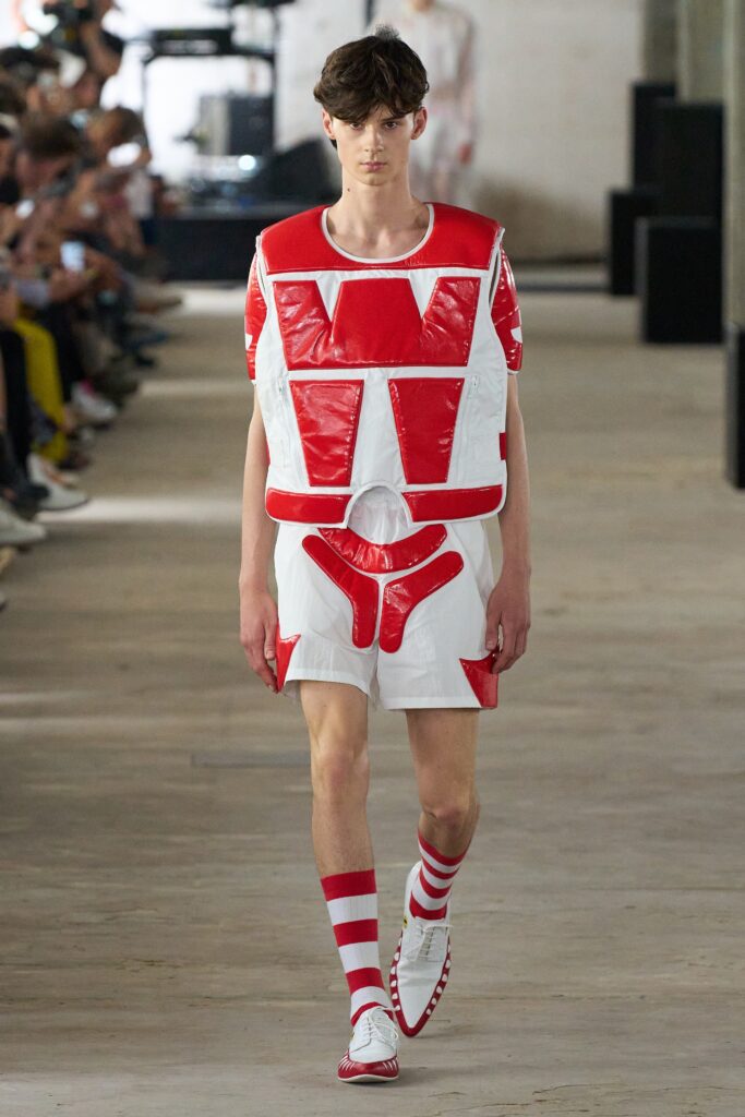 A fitted sleeveless vest and shorts in red and white with a color-blocked design.