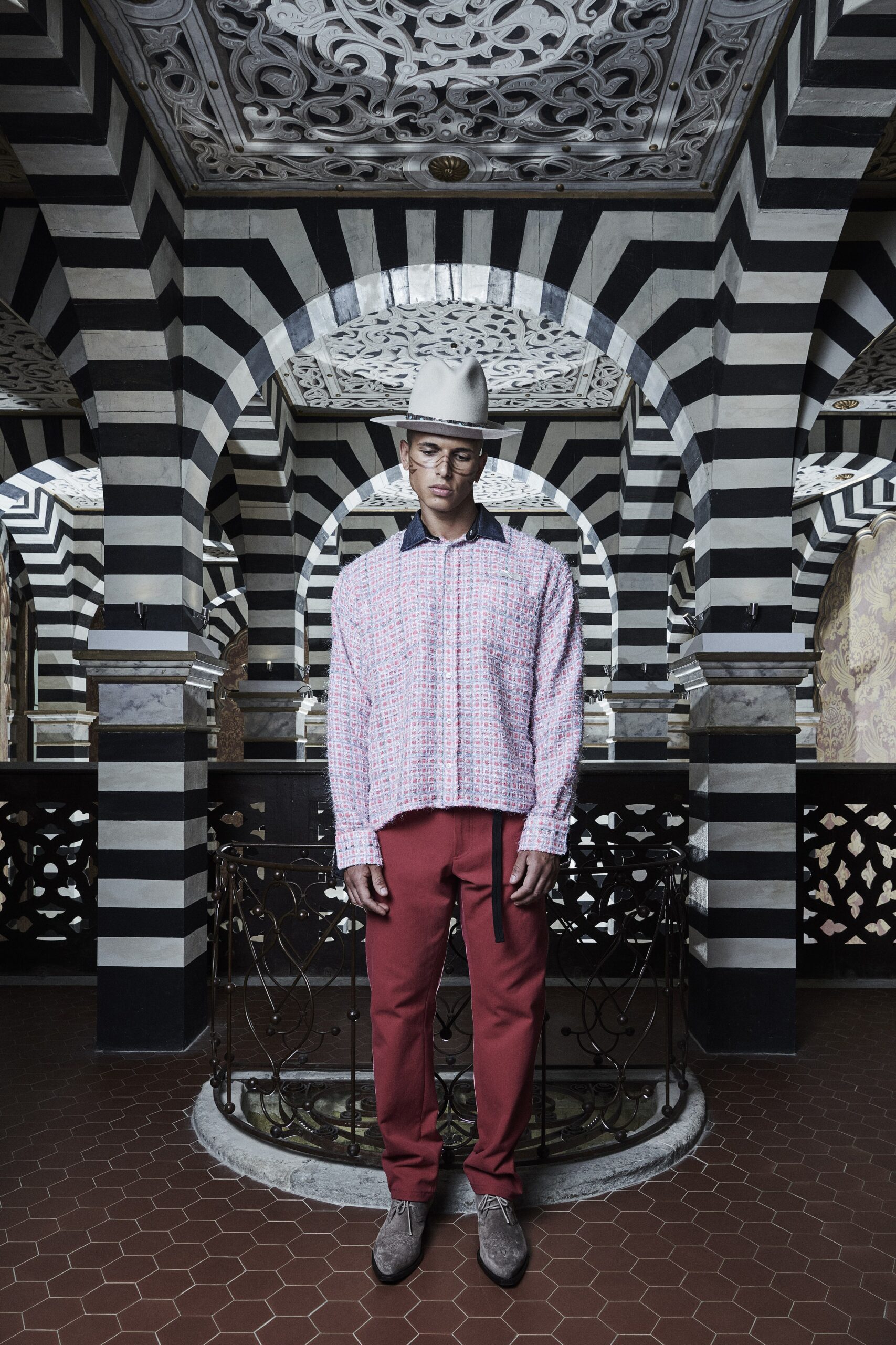 A relaxed pink checked long-sleeve shirt paired with red pants.