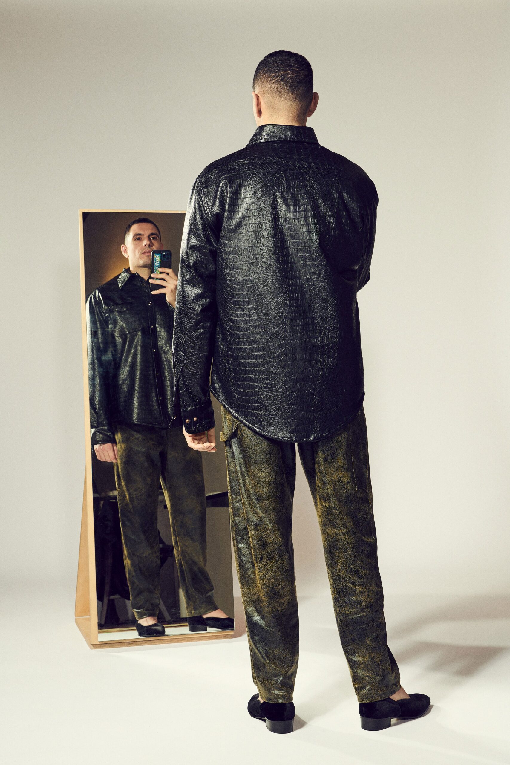 black vinyl relaxed shirt and green pants