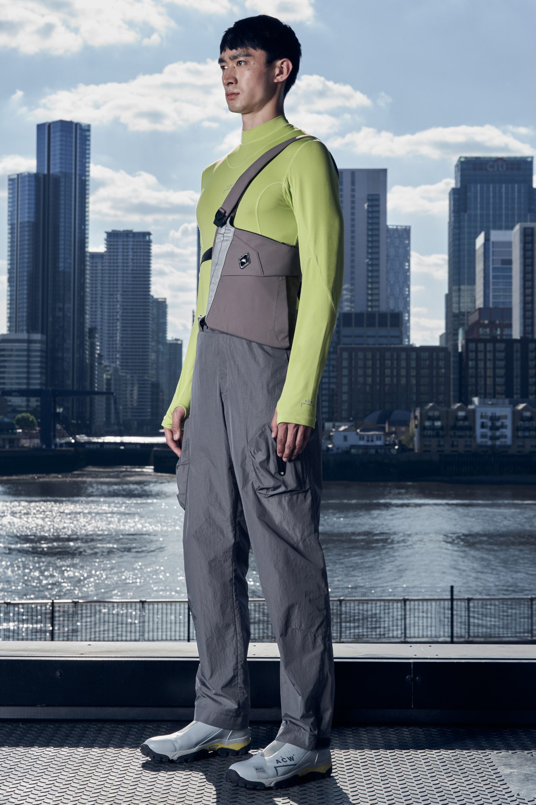 A relaxed gray and green jumpsuit with a zippered front and long sleeves.