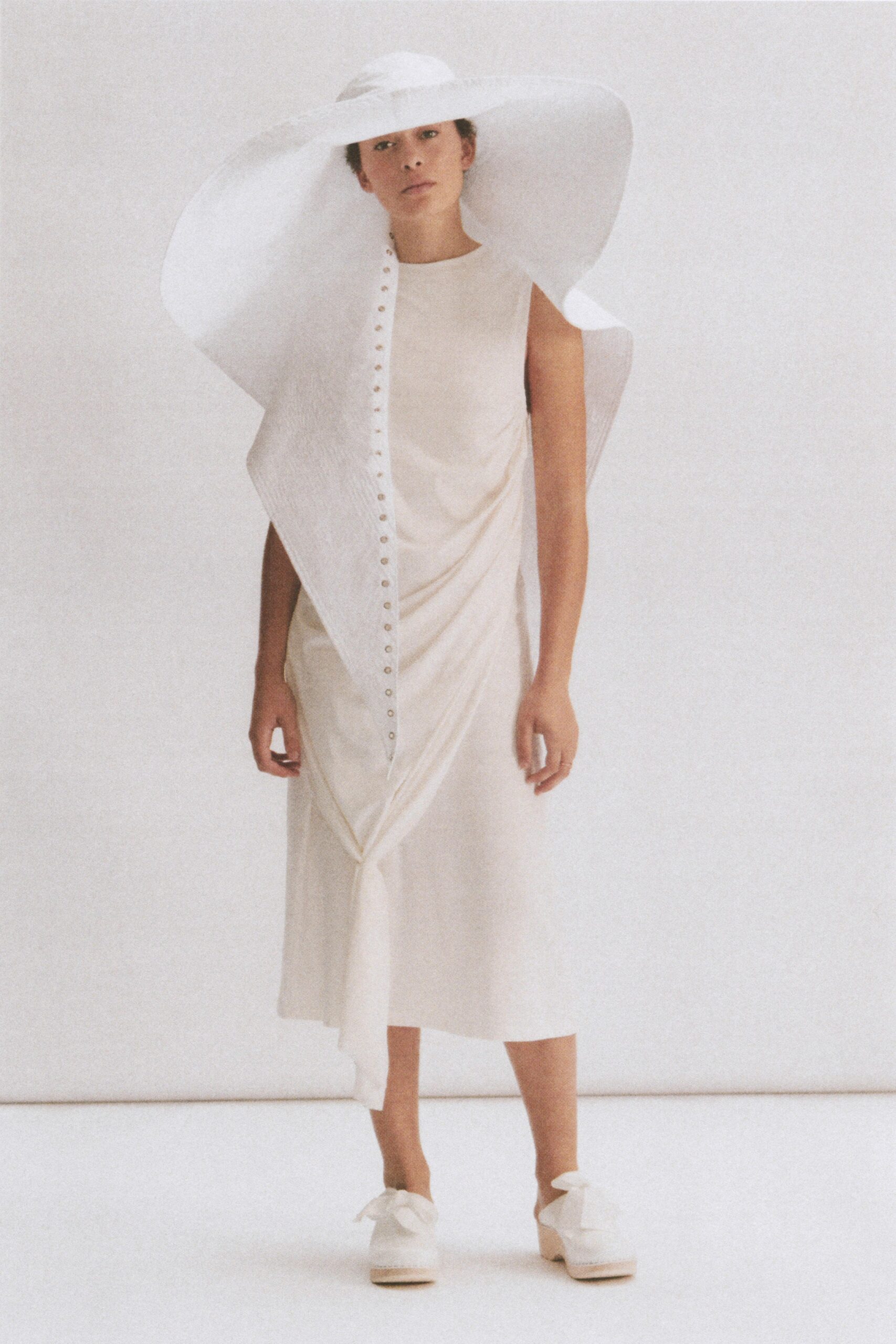 white cotton sleeveless high-neck fitted draped buttoned dress