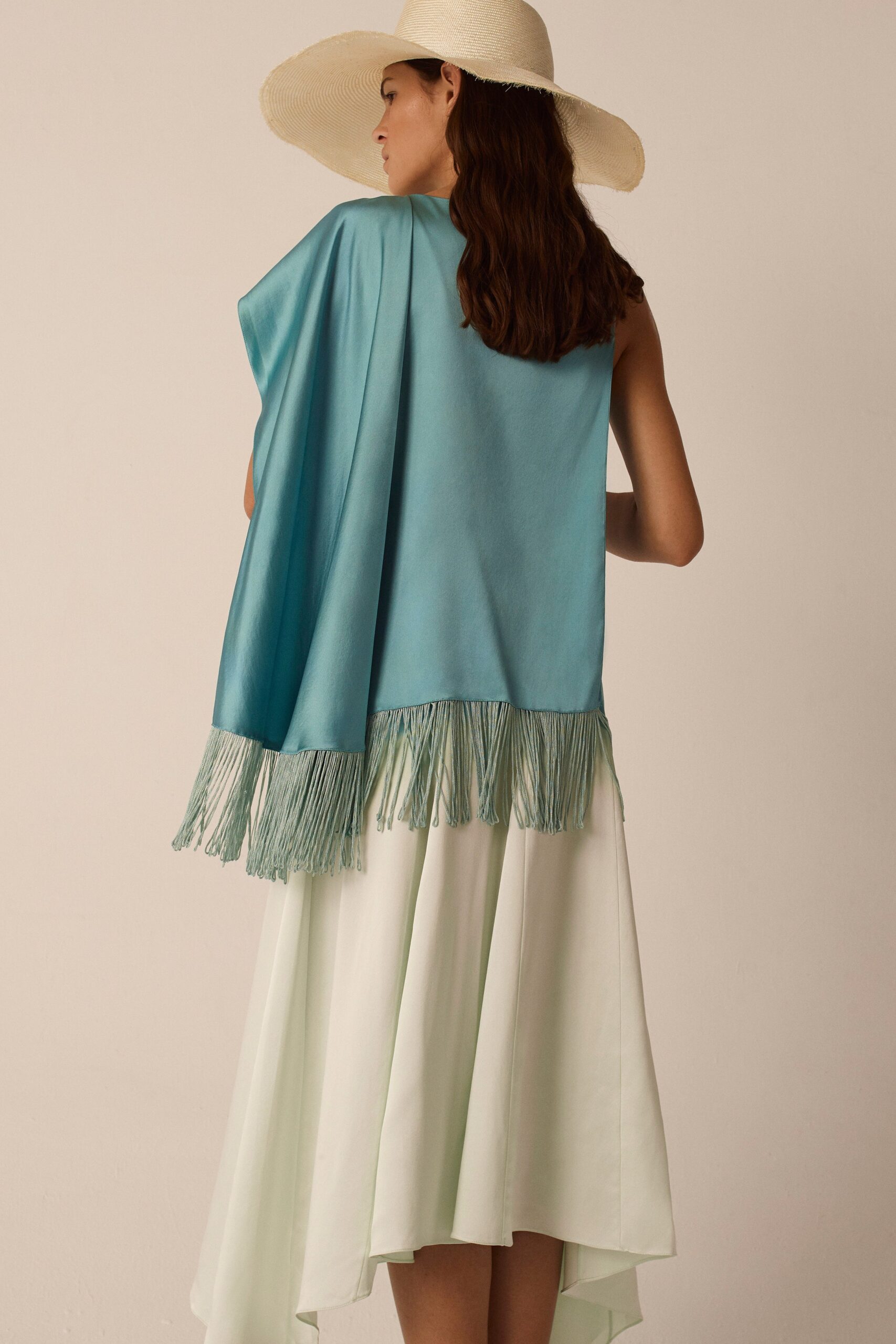 white and green tiered midi dress with blue cape