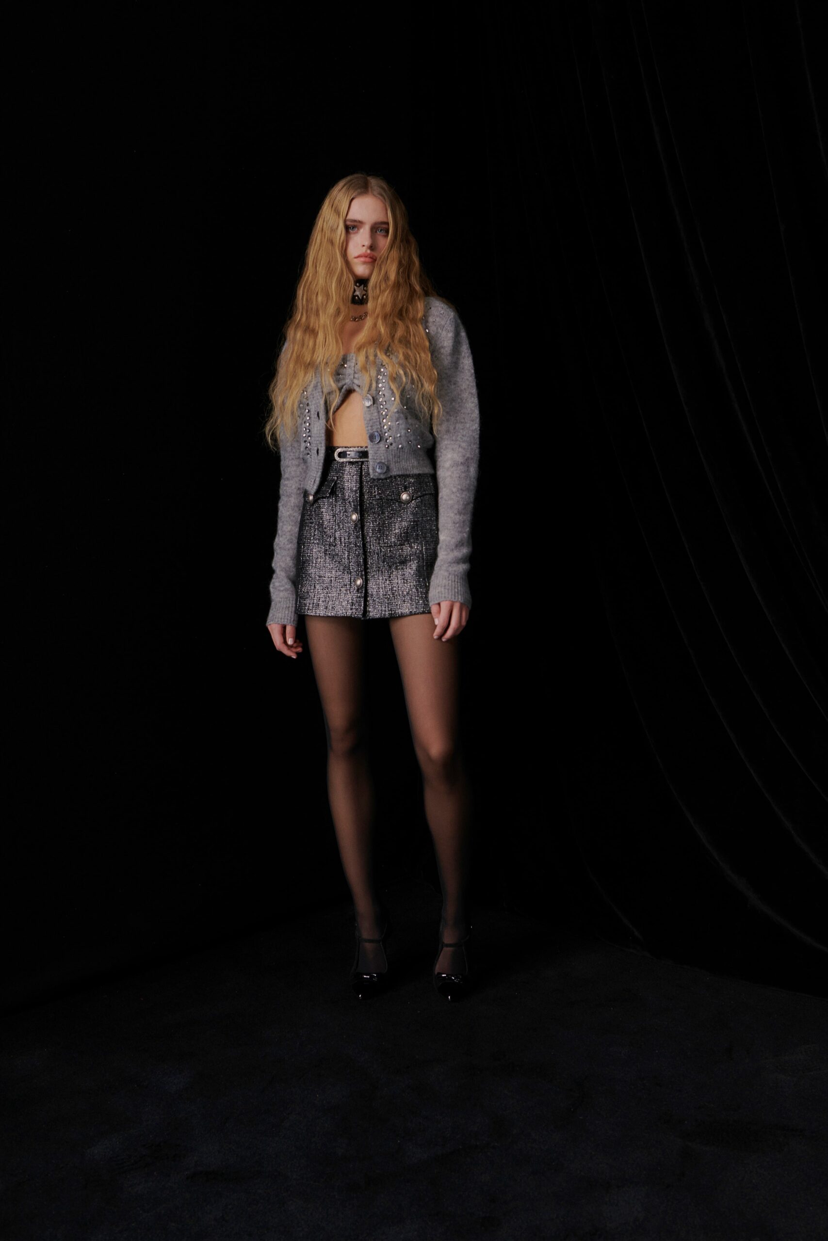 gray fitted cardigan and black mini skirt