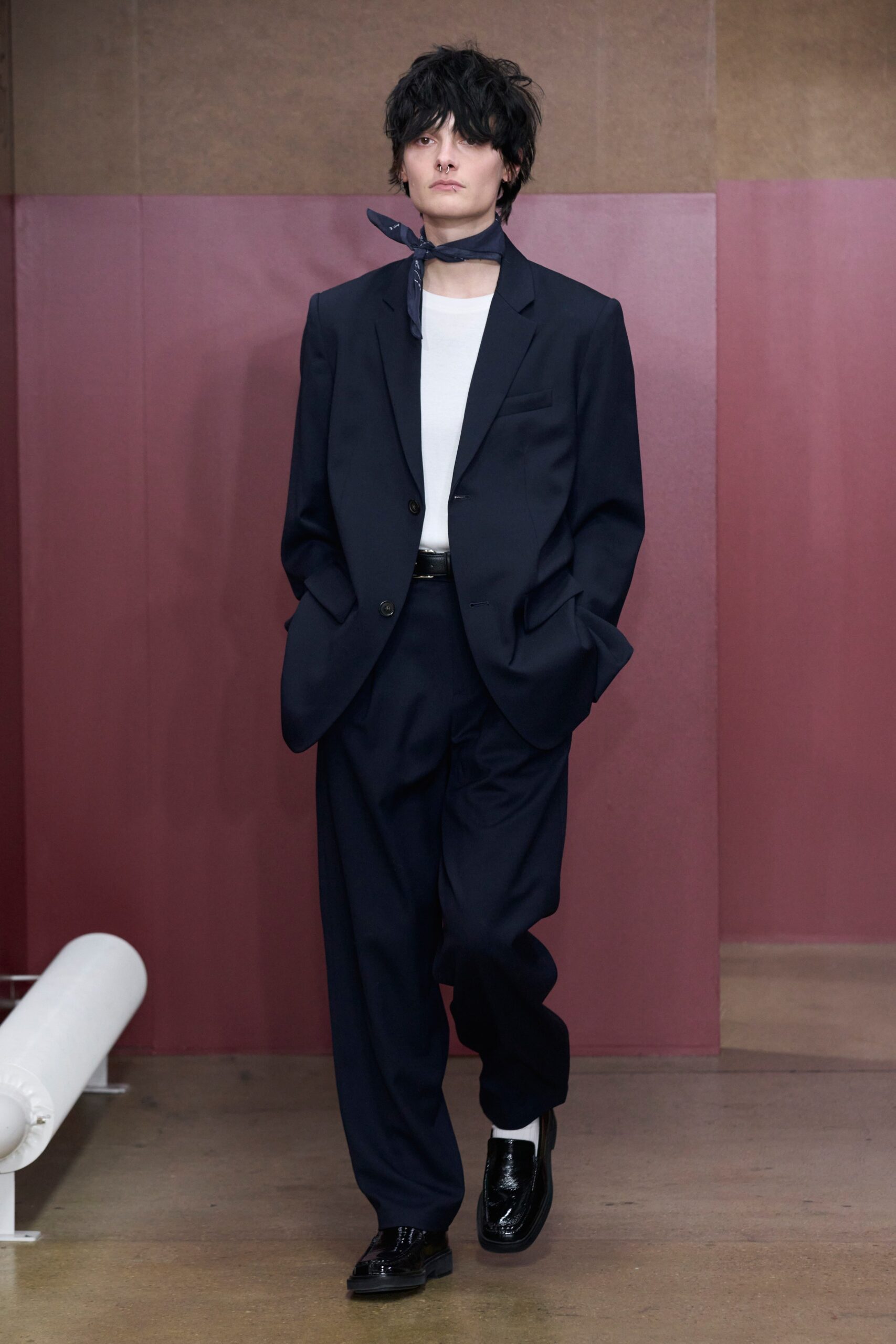 A relaxed fit navy suit with a collared long-sleeve shirt and buttoned details.