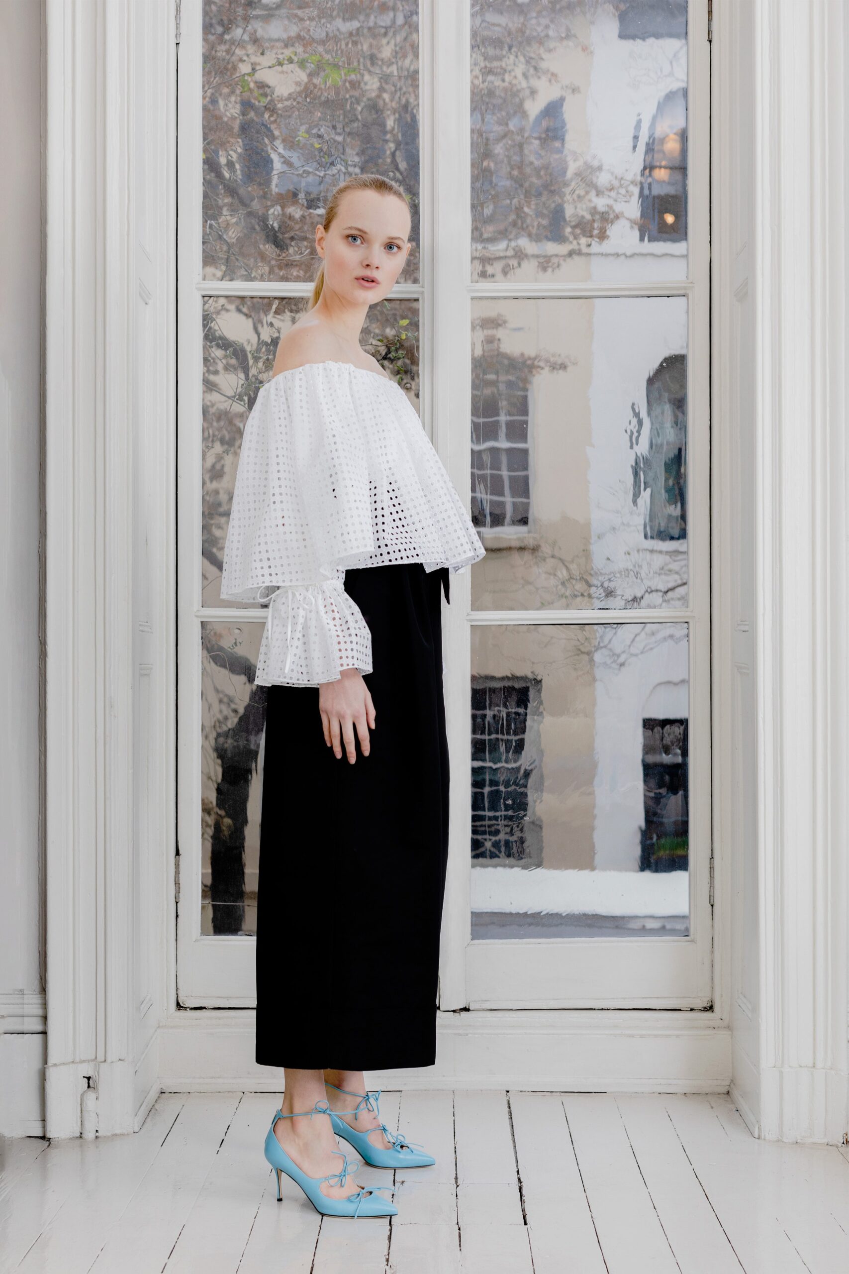 white off-shoulder top with black pants